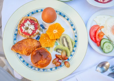 Greek breakfast plate with pastries, fruit, dakos and a boiled egg