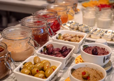 Breakfast buffet with preserves, olives, spreads and yoghurt
