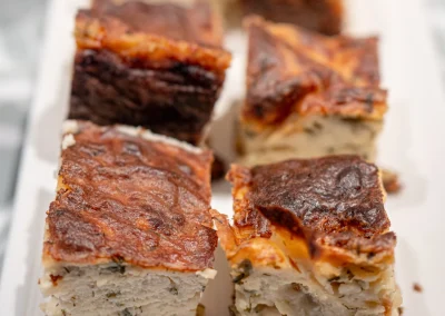 Slices of homemade savoury pie on the Mythos breakfast buffet