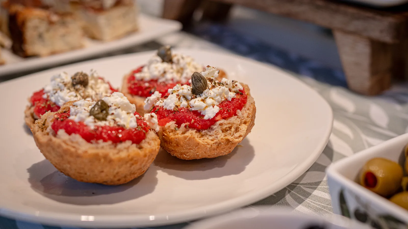 Cretan dakos topped with tomatoes, cheese and capers
