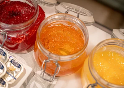 Fruit preserves and homemade lemon curd on the breakfast buffet